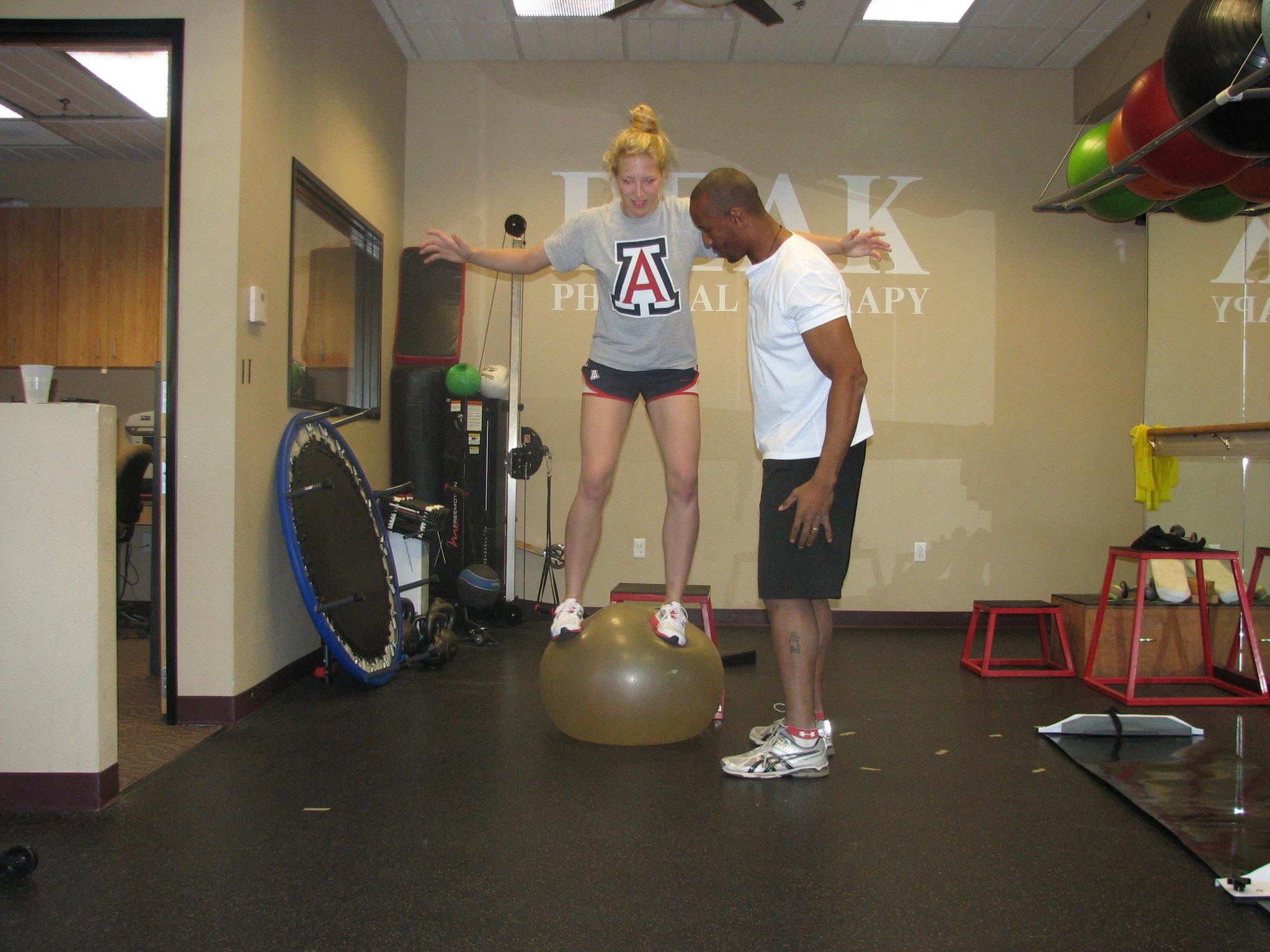 Larry coaching a balance exercise in the gym.